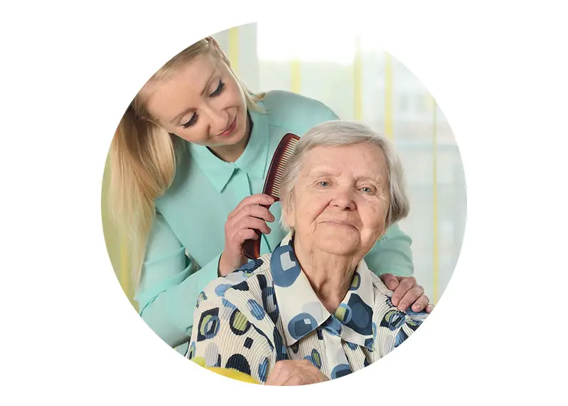 women combing elderly lady's hair